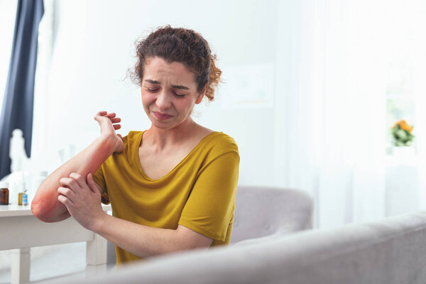 Young girl desperatly scratching her arm