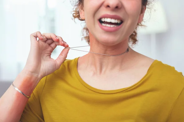 Young lady wearing an allergy provoking necklace — Stock Photo, Image