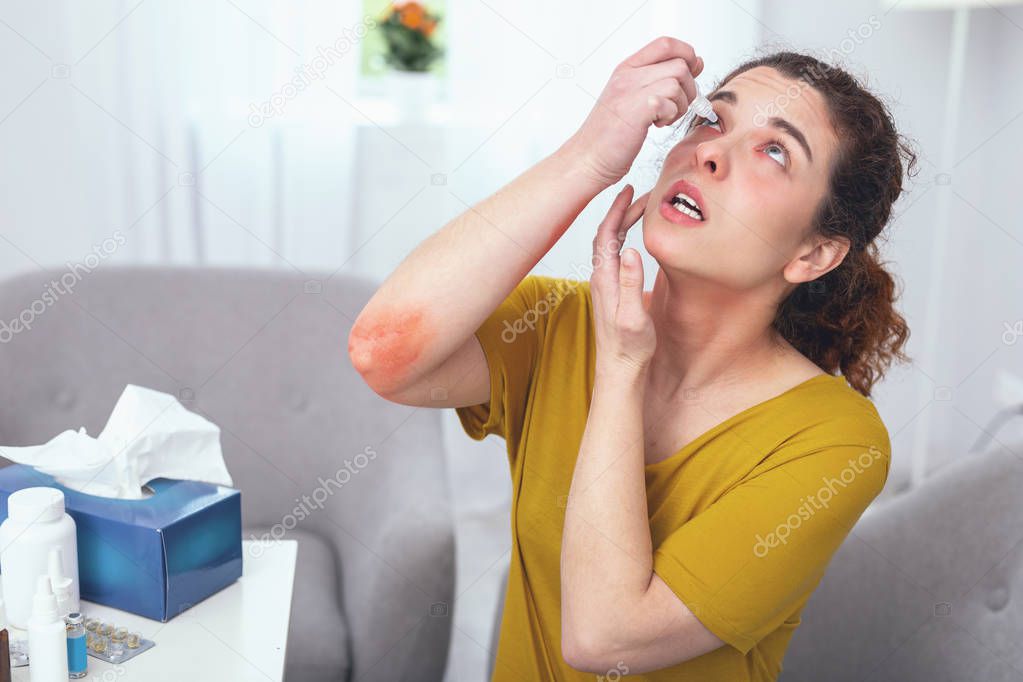 Young lady using eye wash after being an accident victim