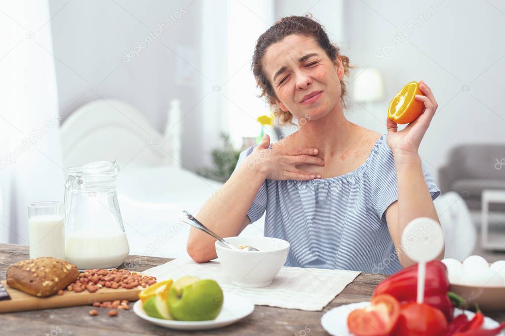 Young woman experiencing a citrus allergy