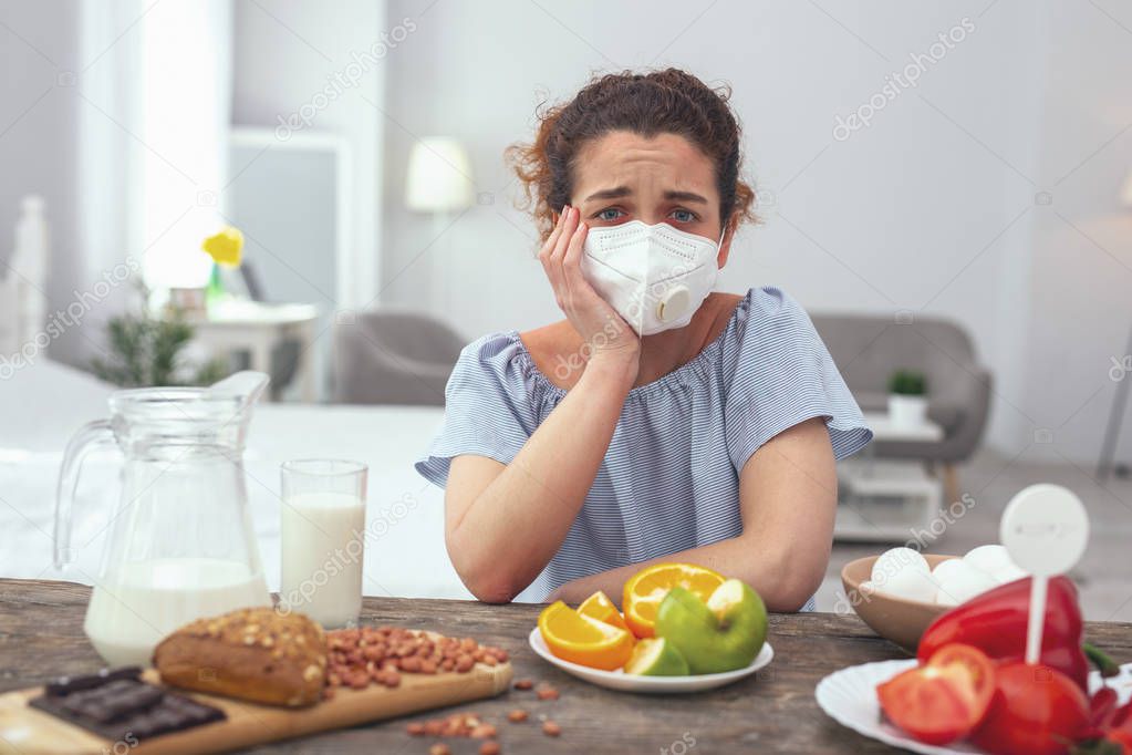 Young woman feeling upset about her multiple allergies