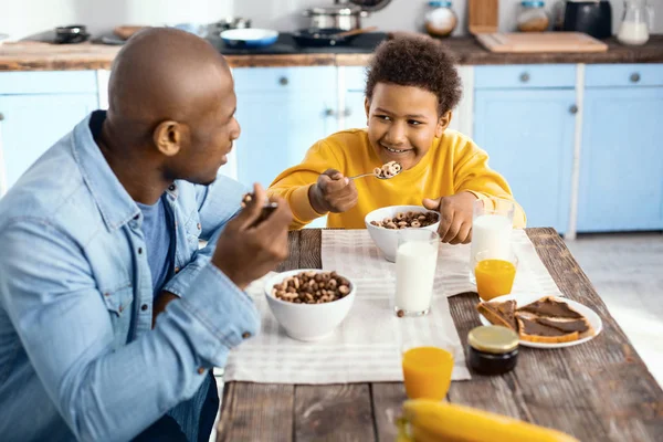 Alegre joven padre y su hijo desayunando juntos —  Fotos de Stock