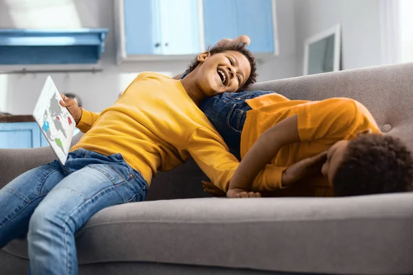 Cheerful boys tickling each other while the boy studying geography — Stock Photo, Image