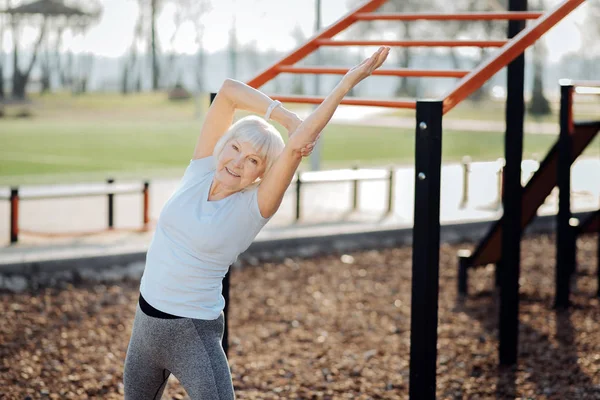 Delighted athletic woman exercising outdoors — Stock Photo, Image