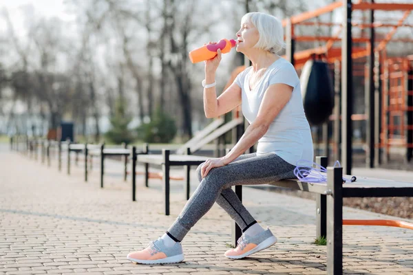 Smiling woman drinking some juice — Stock Photo, Image