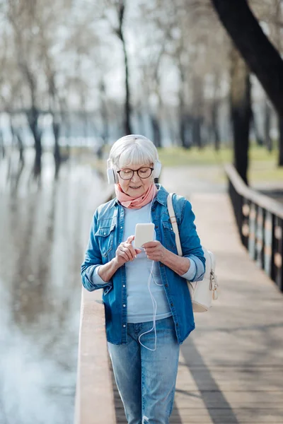 Alert mature woman listening to music