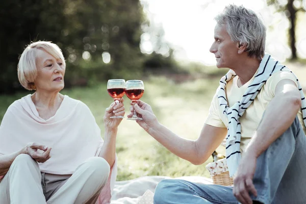 Serious senior woman going to drink wine — Stock Photo, Image