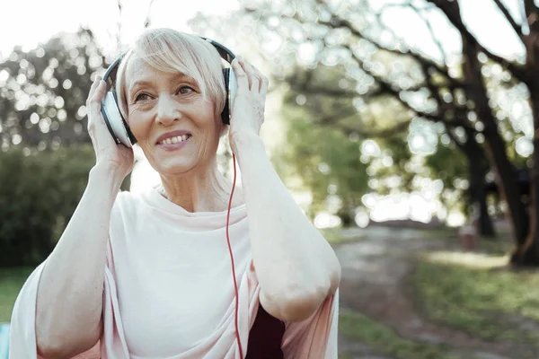 Positive delighted female listening music — Stock Photo, Image