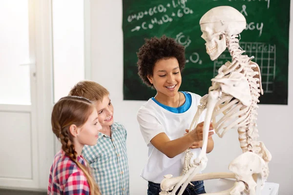 Happy nice children playing with a skeleton