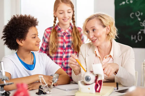 Profesora positiva alegre mirando a su estudiante —  Fotos de Stock