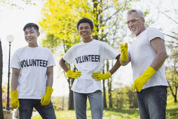 Cheerful three volunteers planning cleaning