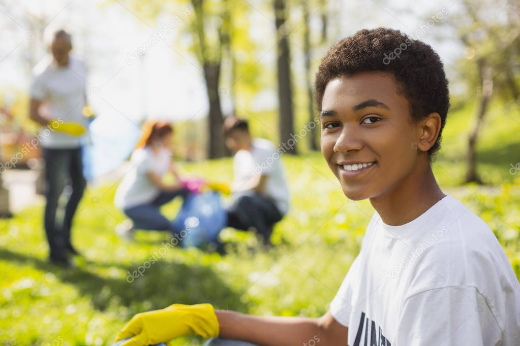 Afro american male volunteer cleansing park