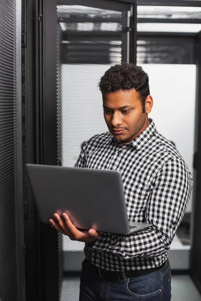 Concentrated IT guy checking software