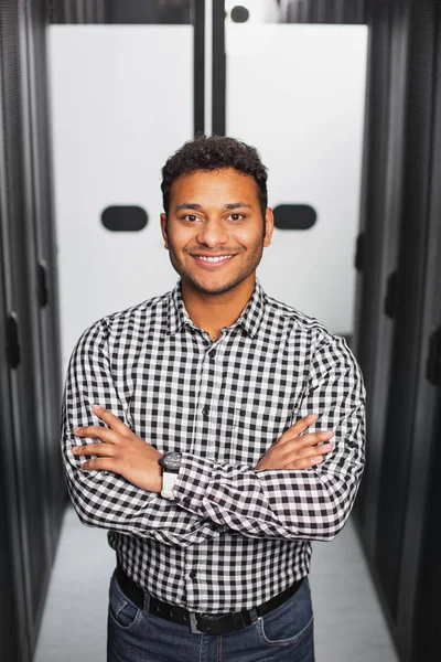 Jovial IT guy posing in server room