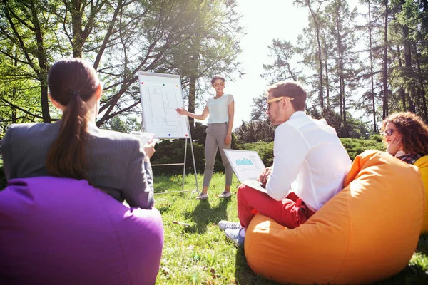 Fröhliche Studentin, die neben der Tafel steht — Stockfoto