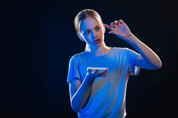 Pleasant young woman looking at the virtual device — Stock Photo, Image