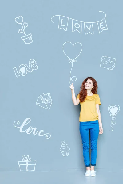 Mujer positiva sonriendo mientras recibe globos lindos —  Fotos de Stock