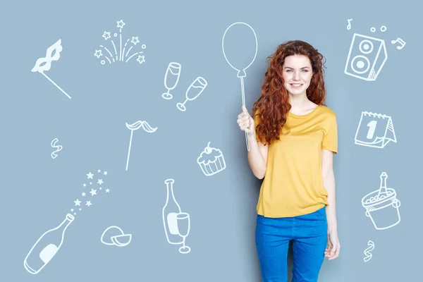 Emotional woman holding a balloon while being at the party — Stock Photo, Image