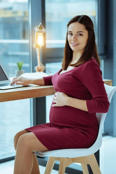 Charming female person smiling while working — Stock Photo, Image