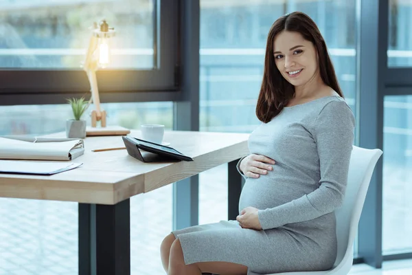 Cheerful female person expecting baby — Stock Photo, Image