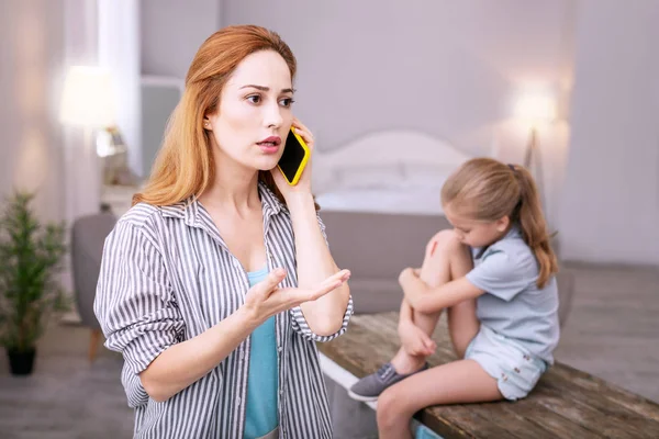 Anxious young woman making a call