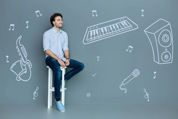 Happy musician smiling while thinking about his future concert — Stock Photo, Image