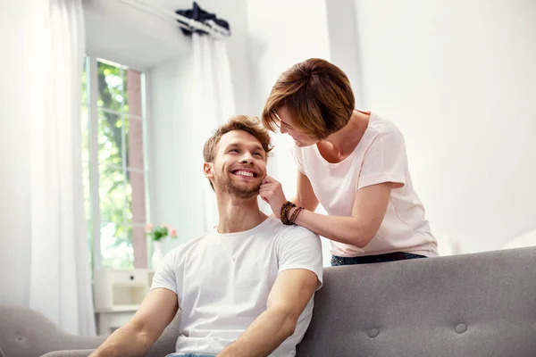 Nice aged woman touching her sons cheek — Stock Photo, Image