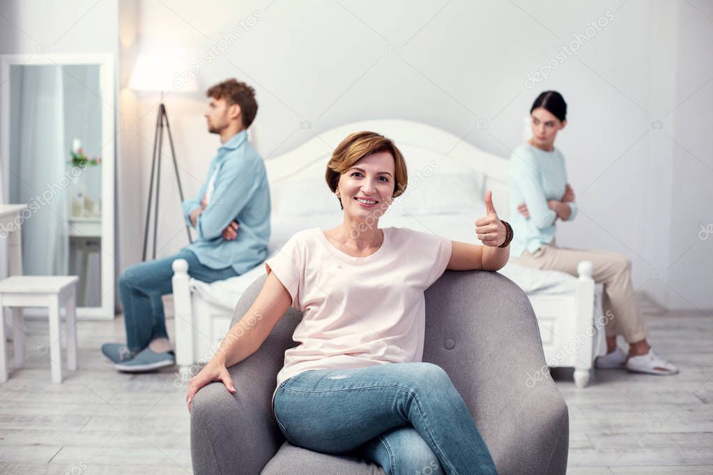 Pleasant nice woman showing thumbs up gesture