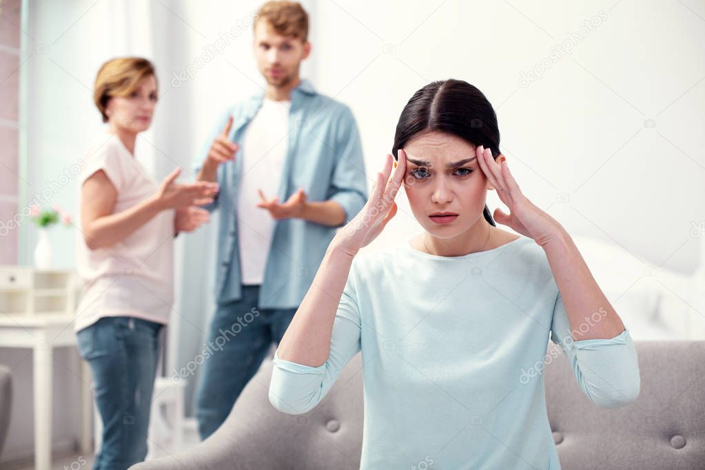 Unhappy depressed woman touching her temples