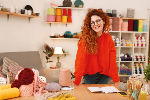 Creative girl in oversize sweater spending time in art studio