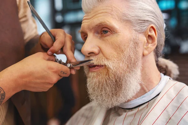 Retrato del hombre concentrado que vislumbraba barbero — Foto de Stock