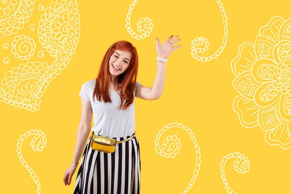 Optimistic young person waving to her friends while meeting them