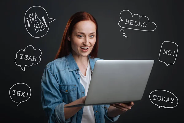 Famoso blogueiro segurando um laptop e lendo comentários positivos — Fotografia de Stock