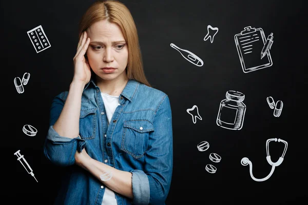 Triste giovane donna che si tocca la testa mentre si sente male e ha mal di testa — Foto Stock