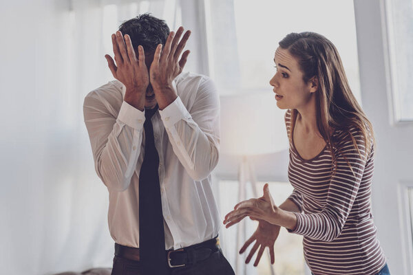 Unhappy young woman shouting at her husband