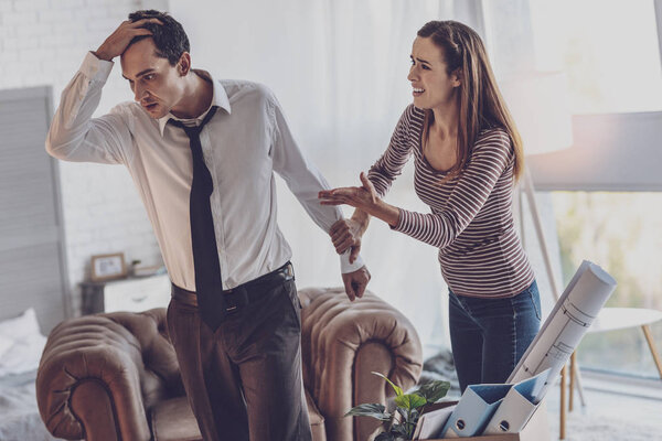 Cheerless young woman fighting with her husband