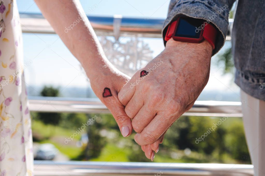 Hands of a positive loving couple