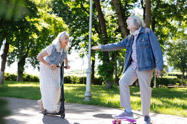 Happy positive man helping his wife