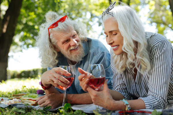 Positive nice woman holding a glass of wine