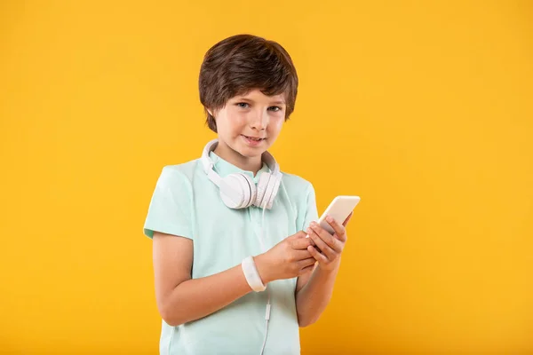 Smiling boy using his modern phone — Stock Photo, Image