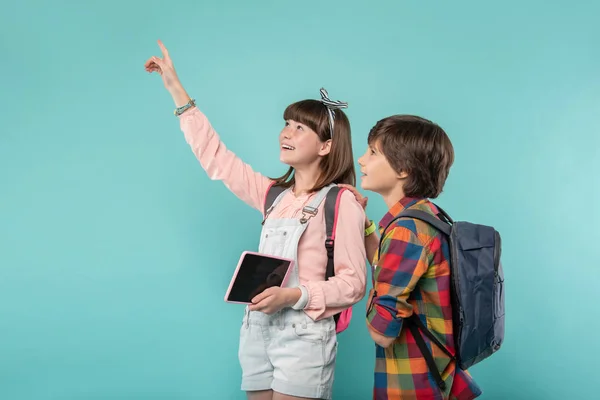 Joyful girl pointing at something