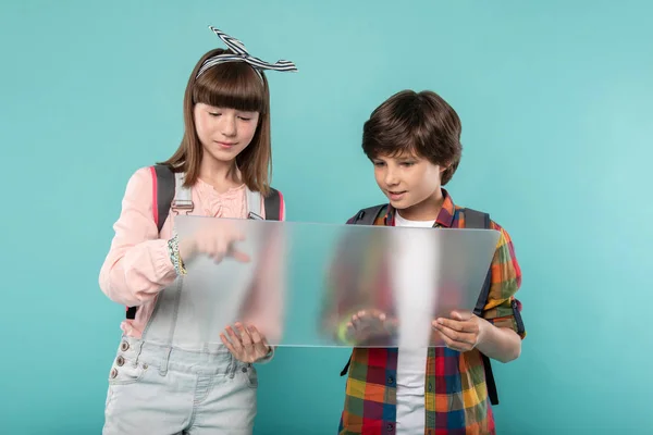 Alert schoolchildren holding a screen — Stock Photo, Image