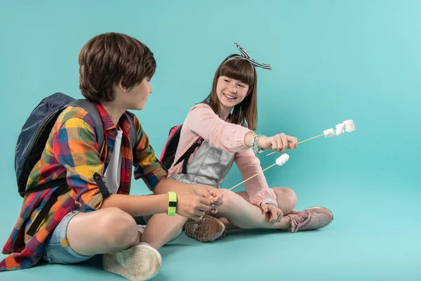 Joyful best friends holding sticks — Stock Photo, Image