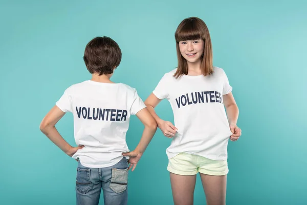 Delighted young volunteers standing together — Stock Photo, Image
