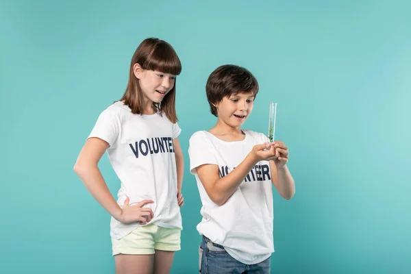 Joyful volunteer holding a plant — Stock Photo, Image