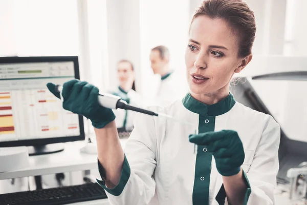 Portrait of thoughtful doctor with analyses and pipette — Stock Photo, Image