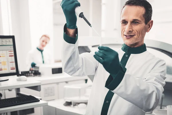 Portrait of concentrated doctor with pipette and test tube — Stock Photo, Image