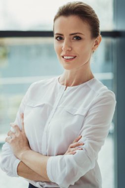 Kollarını geçti ve memnun seyir ile ayakta kendine güvenen insan kaynakları yöneticisi