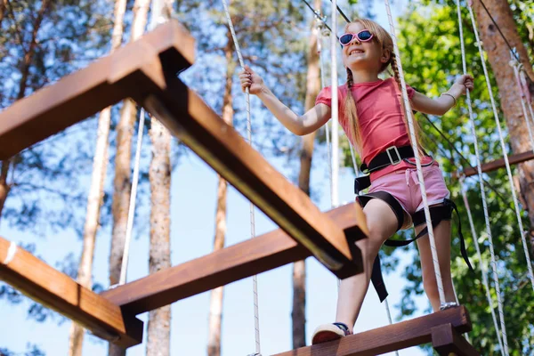 Cute little girl moving around rope park — Stock Photo, Image