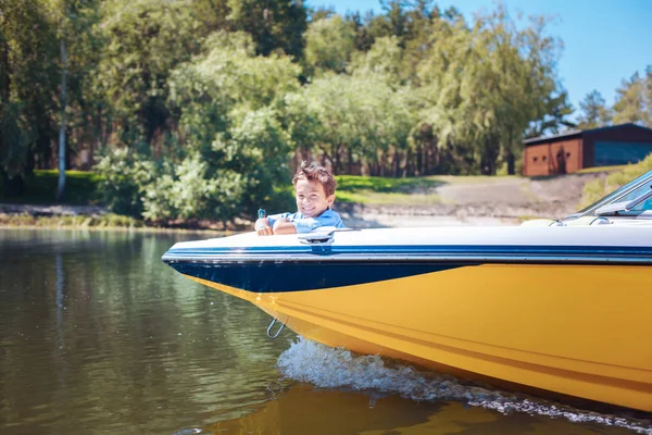 Cute little boy relaxing on motorboat bow — Stock Photo, Image